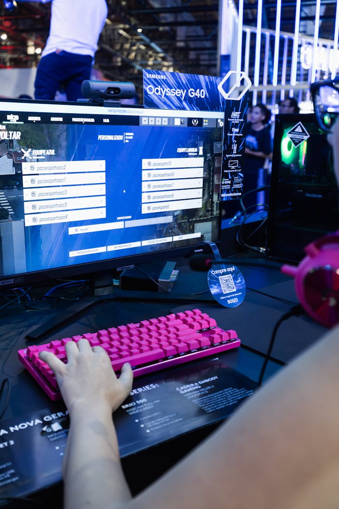 Colorful gaming setup featuring a pink mechanical keyboard at a trade show.