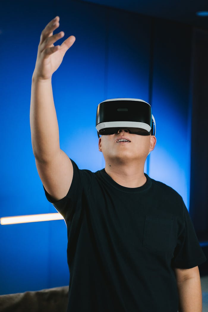 Adult man enjoying virtual reality gaming indoors, reaching up.